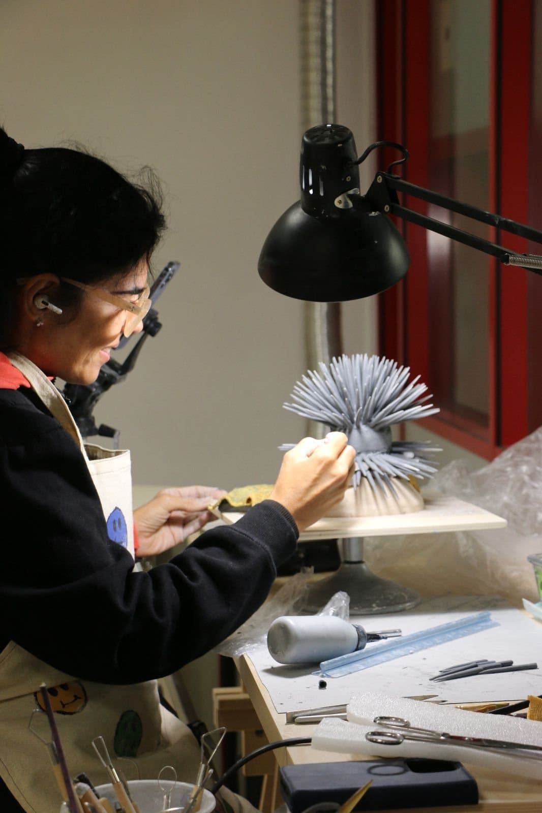 Renata shaping the spines of a porcelain sea urchin